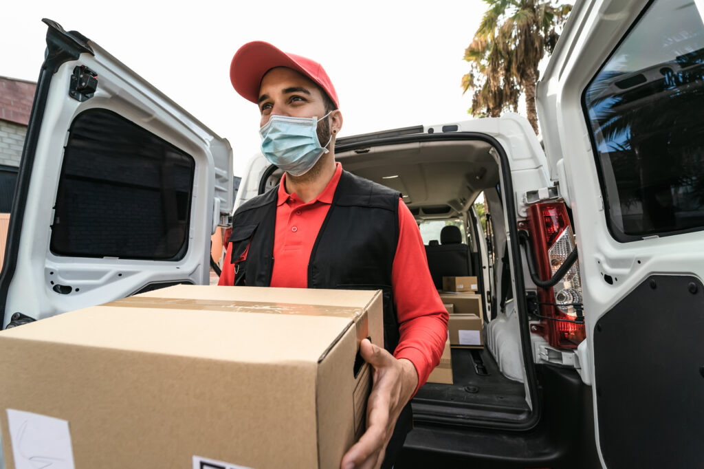 Young delivery man carrying